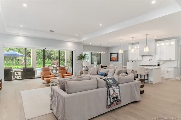 a living room with furniture and large windows