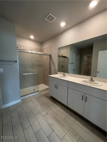 a bathroom with a double vanity sink and a mirror