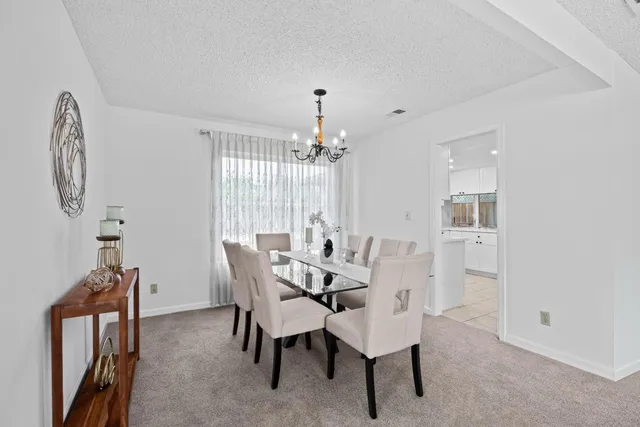 a dining room with furniture and window