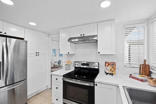 a kitchen with a stove and a refrigerator