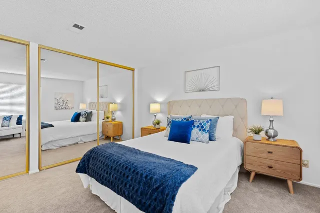 a bedroom with a bed and a large window