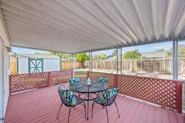 a outdoor dining space with furniture and wooden floor