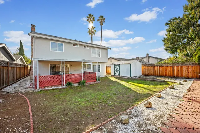 a view of a house with a yard and tree