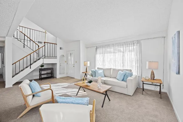 a living room with fireplace furniture and a wooden floor