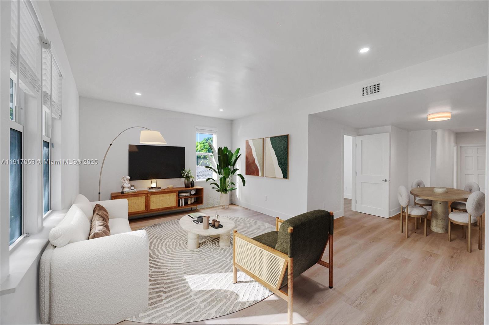 893 Northeast 81st Street, Unit 2 Miami, FL 33138 - Photo 5 of 7 a living room with furniture and a flat screen tv