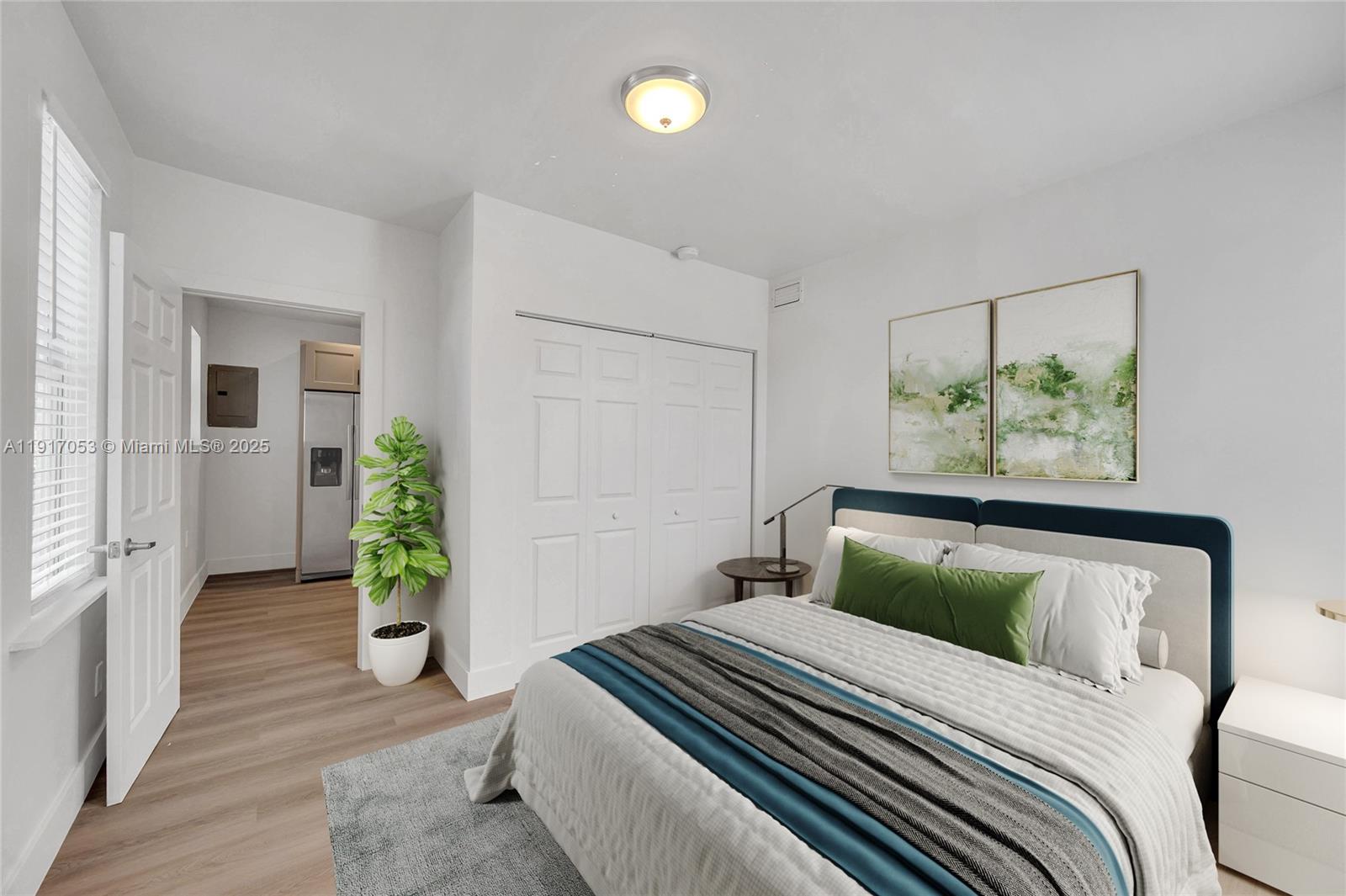 893 Northeast 81st Street, Unit 2 Miami, FL 33138 - Photo 6 of 7 a bedroom with furniture and a potted plant