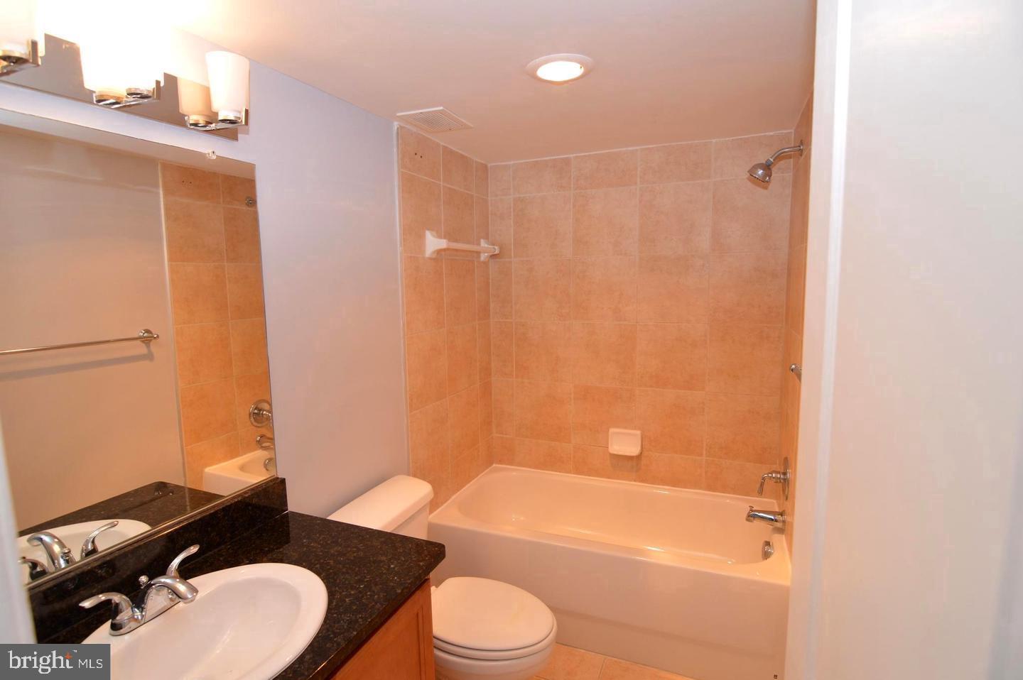 1220 Blair Mill Road, Unit 1007 Silver Spring, MD 20910 - Photo 10 of 27 a bathroom with a toilet a sink and bathtub