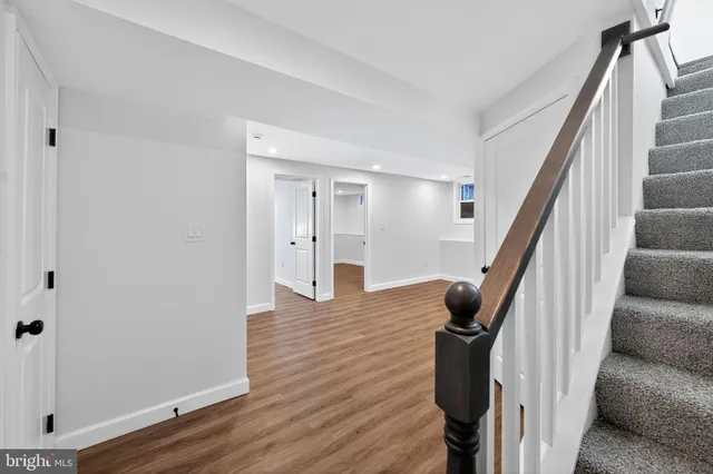 a view of entryway with wooden floor and stairs