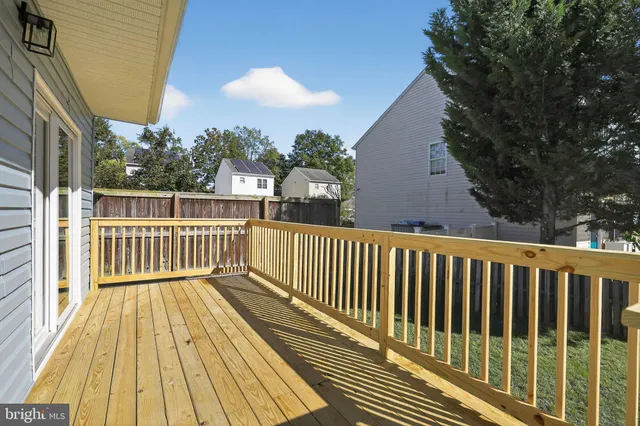 a view of balcony with wooden floor and fence