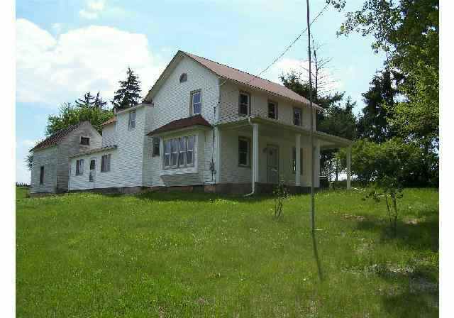 6331 East Center Road Stockton, IL 61085 - Photo 1 of 8 a front view of house with a garden