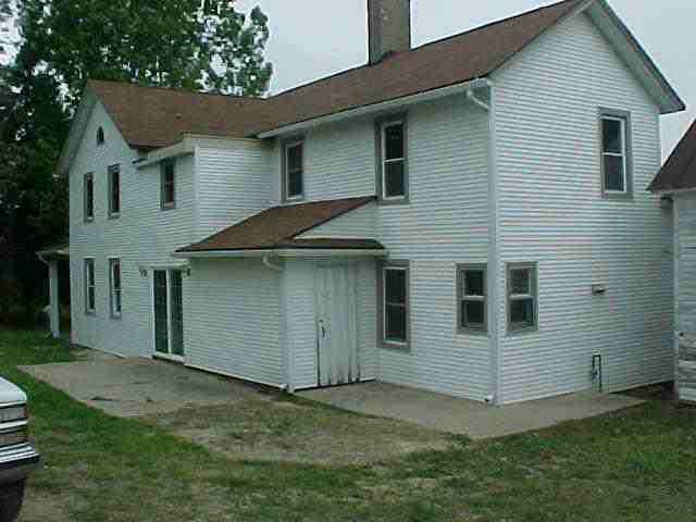 6331 East Center Road Stockton, IL 61085 - Photo 8 of 8 a view of backyard of house with wooden fence