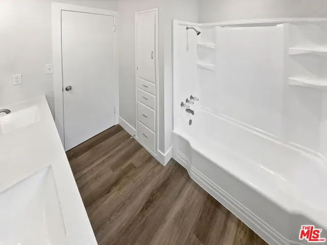a bathroom with a tub and shower