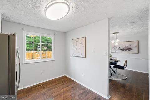 a view of a dining room with furniture wooden floor and chandelier