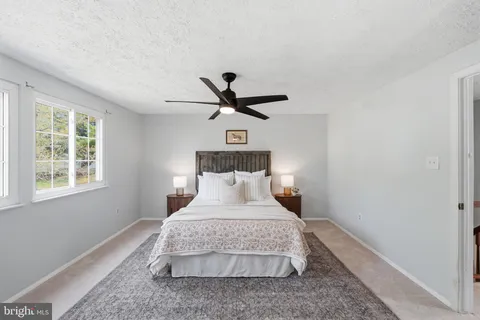 a bedroom with a bed and lamp