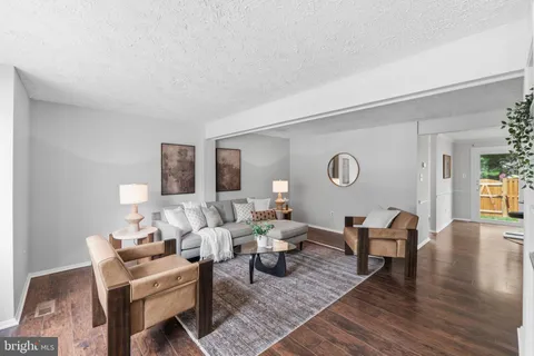 a view of a hallway with wooden floor and stairs