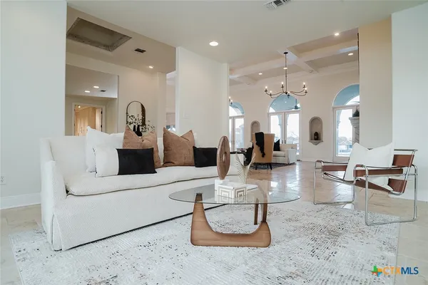 a living room with furniture and a large mirror