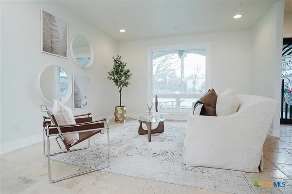 a living room with furniture and a large window