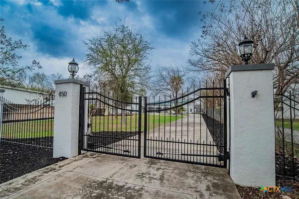a view of a wrought iron fences in front of house