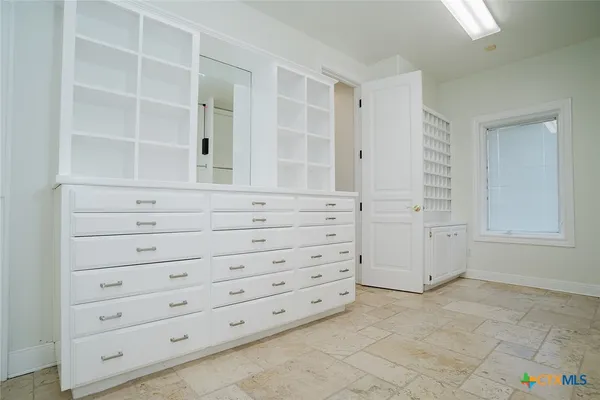 a white bath tub sitting in a bathroom next to a window
