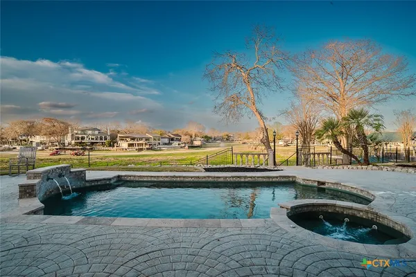 a view of swimming pool with outdoor seating and plants