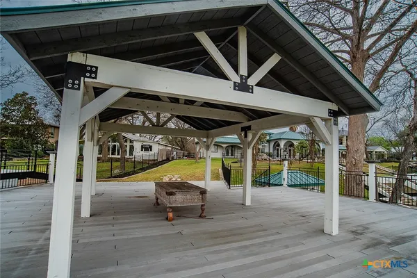 a view of a roof deck with chair and wooden floor