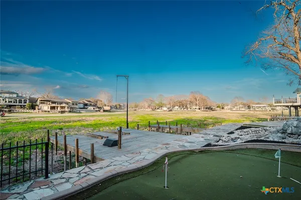 a view of a park with iron fence