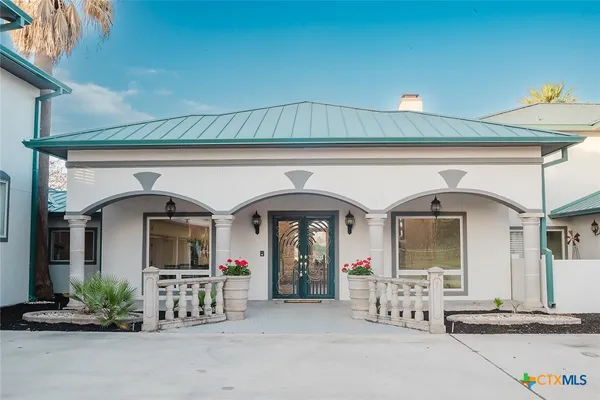 a front view of a house with garden