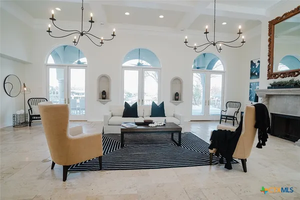 a living room with couches a table and chairs with wooden floor