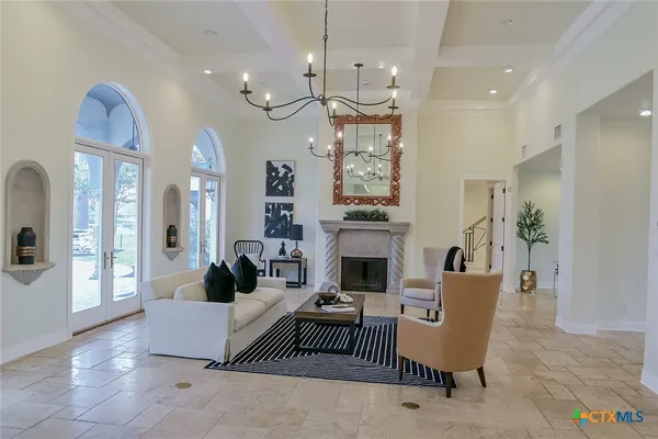 a living room with furniture and a chandelier