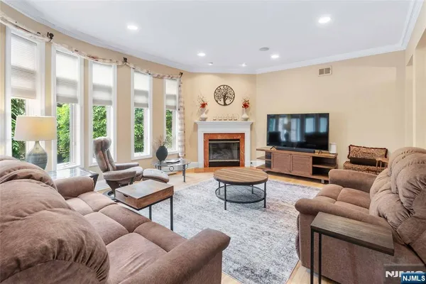a living room with furniture fireplace and a large window