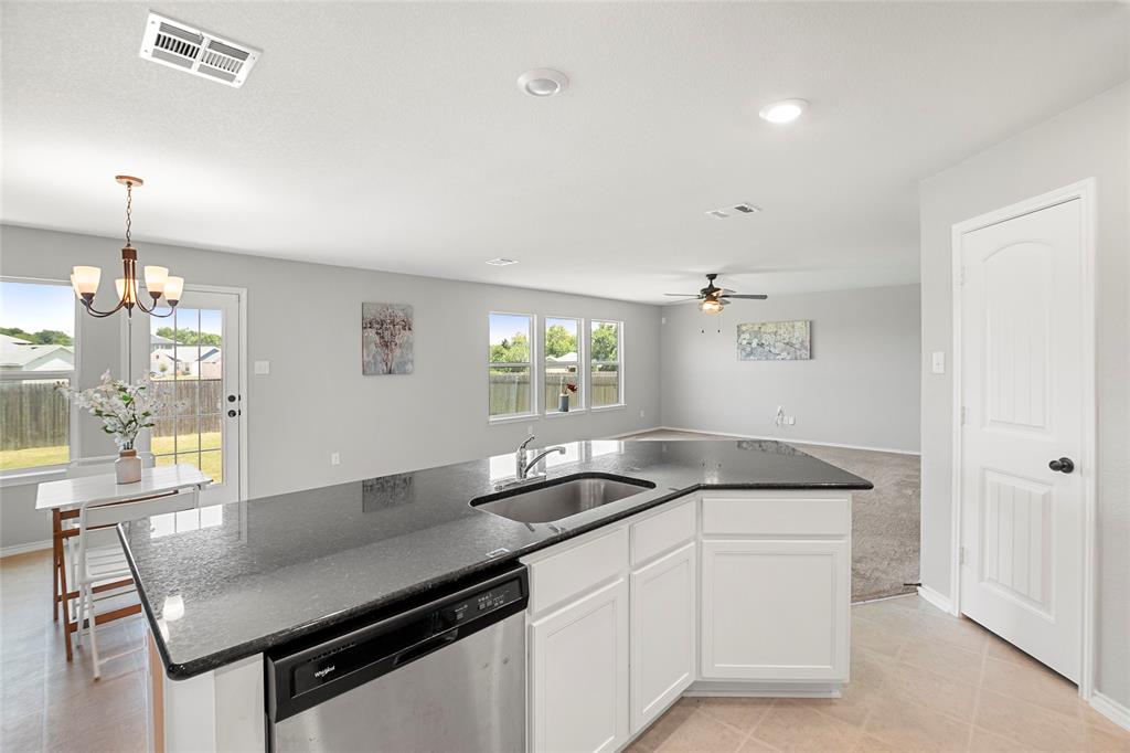 117 West Point Way Elgin, TX 78621 - Photo 20 of 21 An open floor plan seamlessly connects the kitchen island to adjacent living spaces.