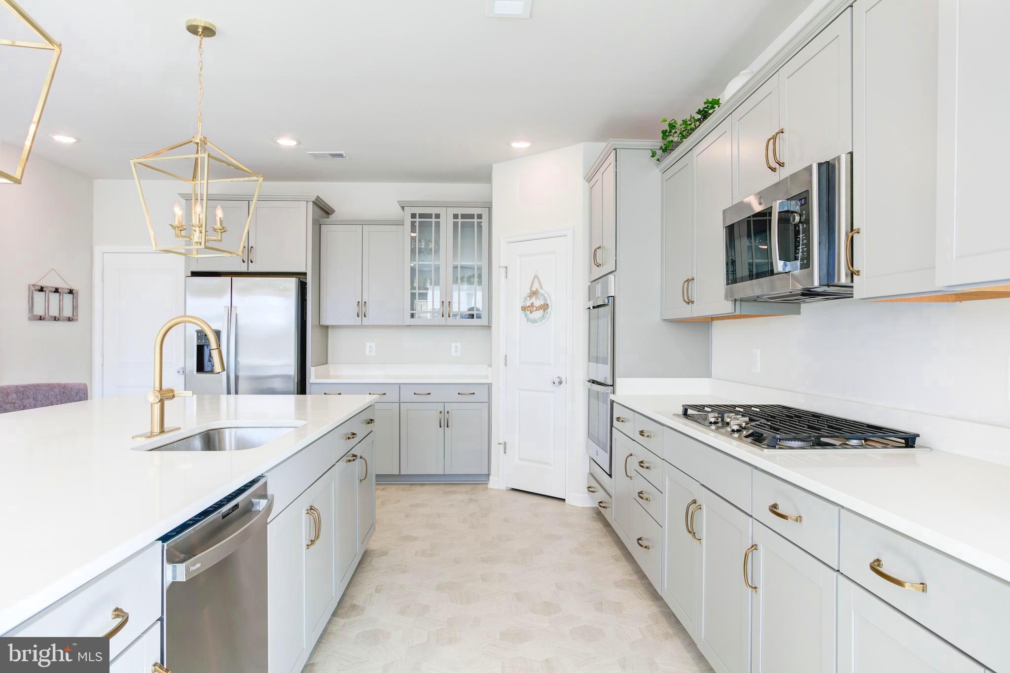 13402 Maymount Drive Culpeper, VA 22701 - Photo 16 of 25 a kitchen with granite countertop cabinets stainless steel appliances and wooden floor