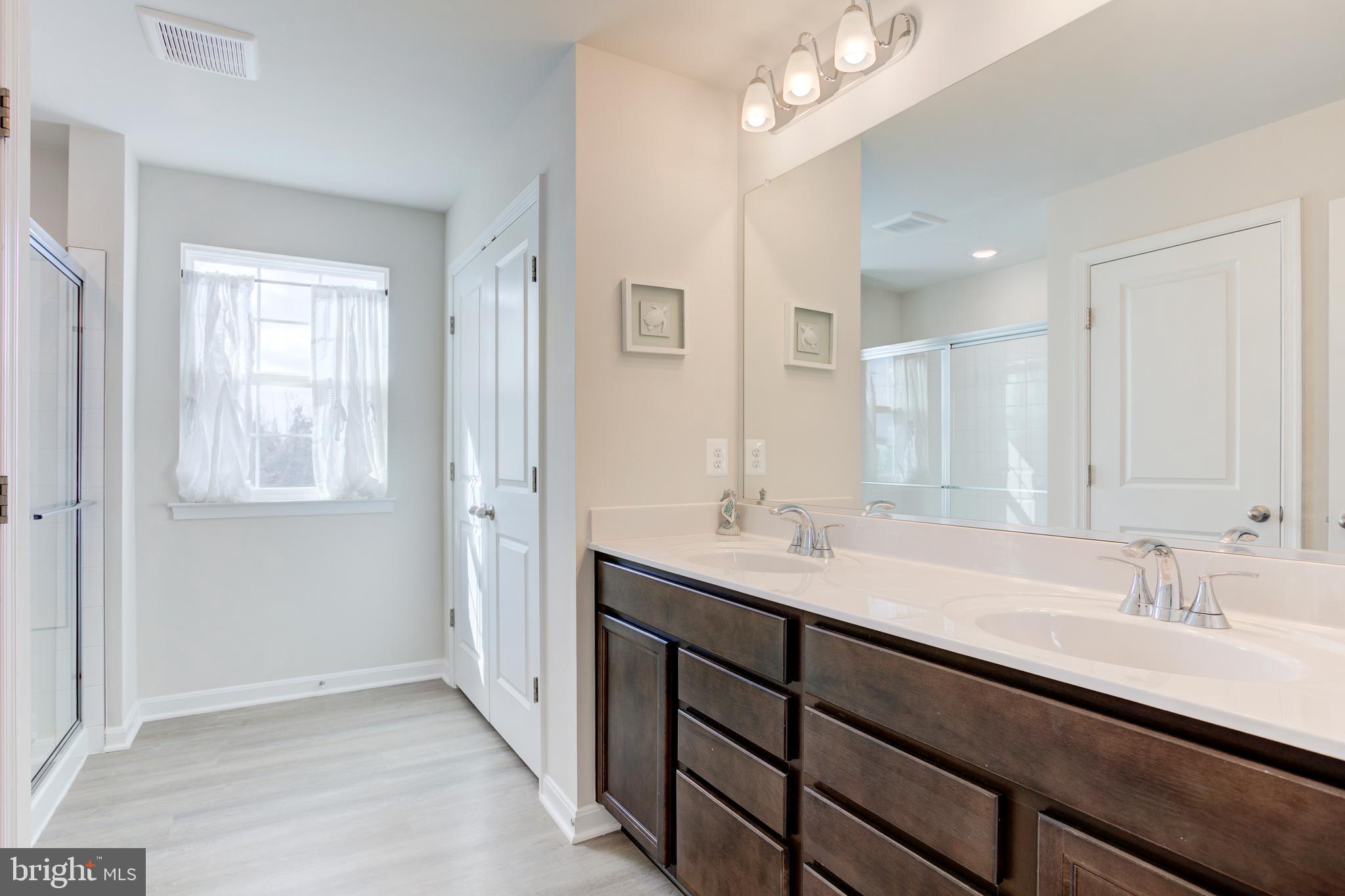 13402 Maymount Drive Culpeper, VA 22701 - Photo 18 of 25 a bathroom with double vanity sinks and a mirror
