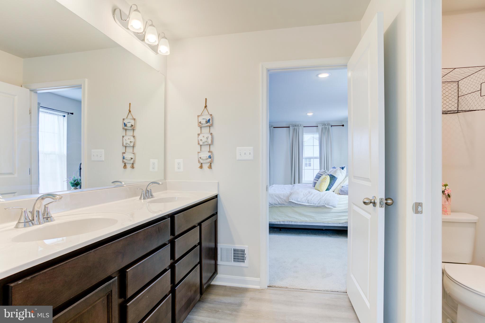 13402 Maymount Drive Culpeper, VA 22701 - Photo 19 of 25 a en suite bathroom with double sink and a mirror