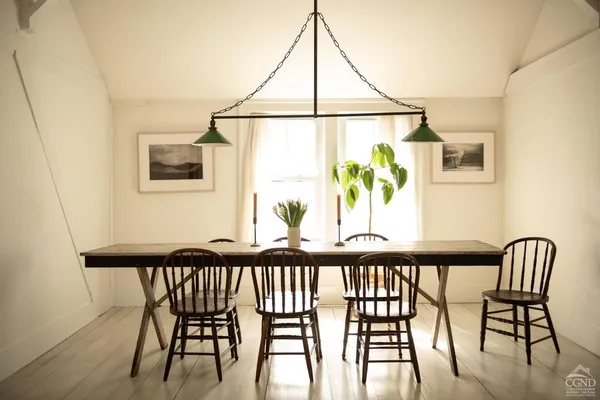a view of a dining room with furniture and window
