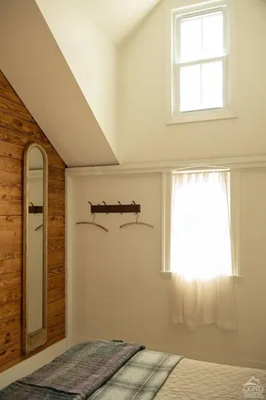 a bedroom with a bed and a desk