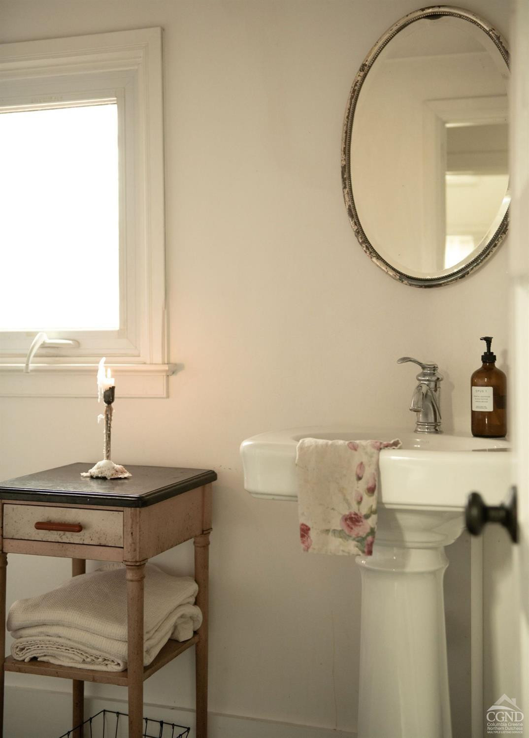 222 Main Street Germantown, NY 12526 - Photo 25 of 36 a bathroom with a sink and a mirror