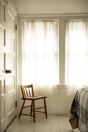 a bedroom with a bed and a painting on the wall