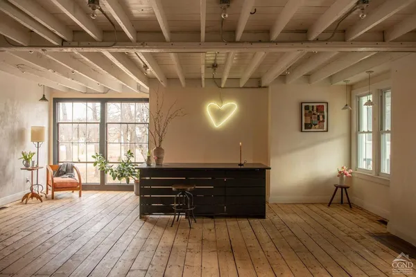a living room with a fireplace and wooden floor