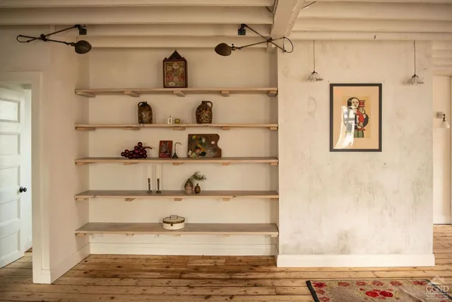 a view of a room with wooden floor