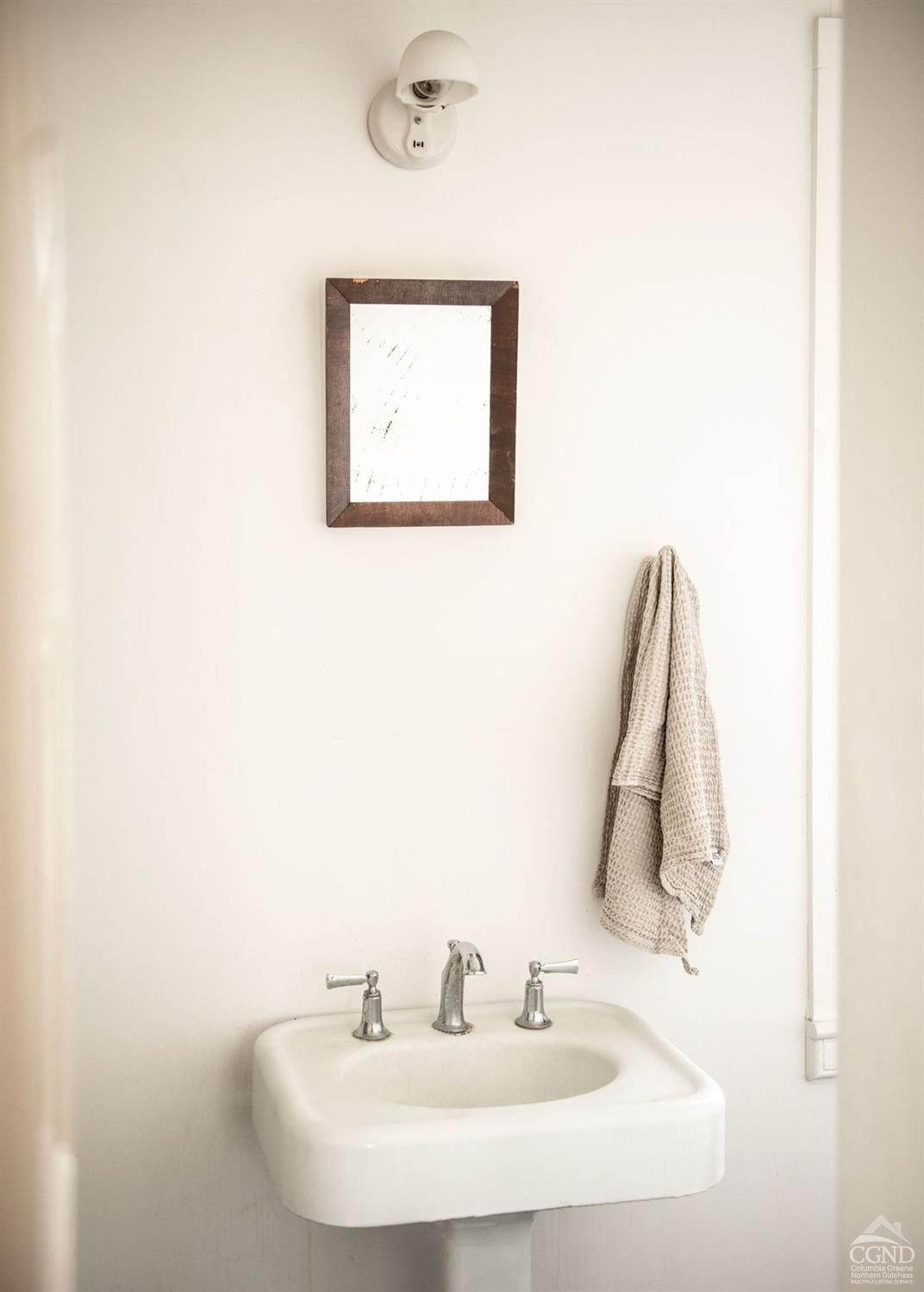 222 Main Street Germantown, NY 12526 - Photo 10 of 36 a bathroom with a sink and a mirror