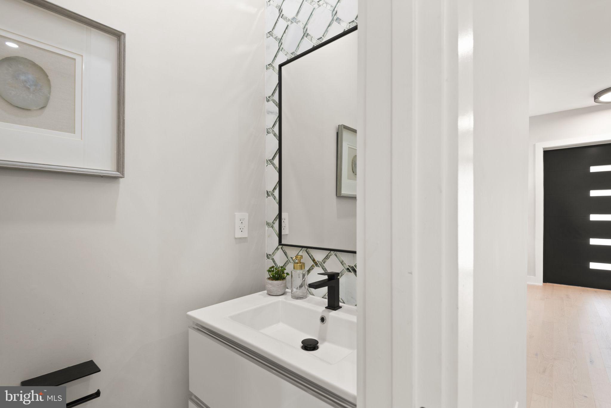 1610 Foxhall Road Northwest Washington, DC 20007 - Photo 14 of 66 a bathroom with a sink mirror and vanity