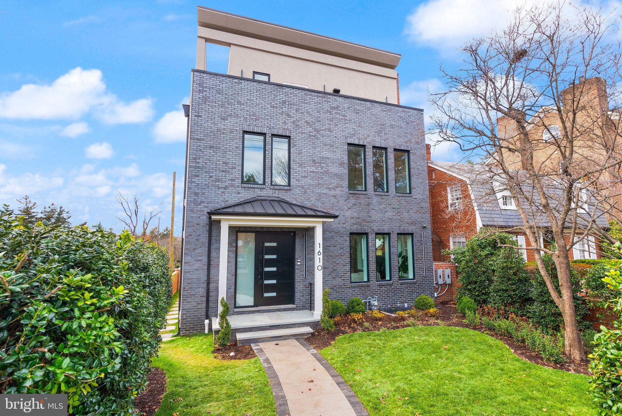 1610 Foxhall Road Northwest Washington, DC 20007 - Photo 2 of 66 a front view of a house with garden
