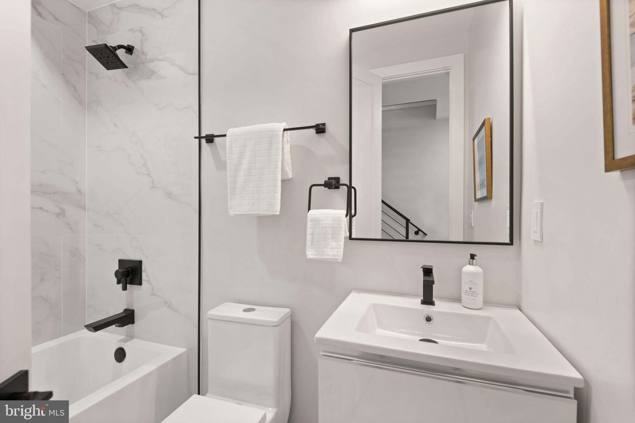 1610 Foxhall Road Northwest Washington, DC 20007 - Photo 21 of 66 a bathroom with a sink and mirror with toilet