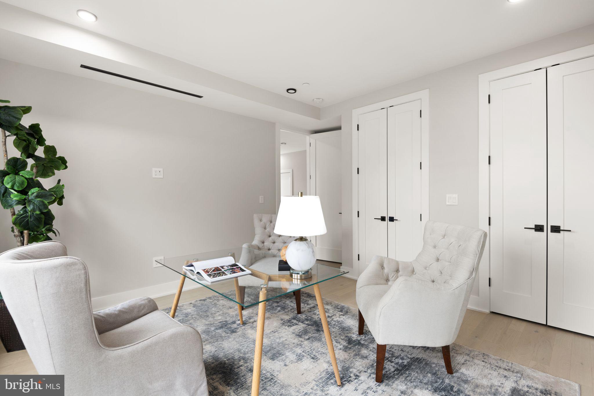 1610 Foxhall Road Northwest Washington, DC 20007 - Photo 30 of 66 a living room with furniture and a potted plant