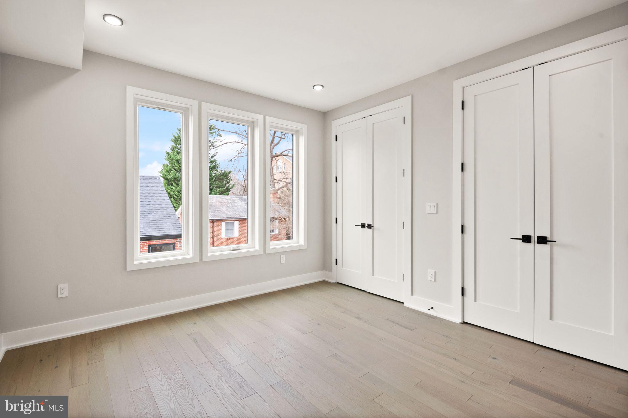 1610 Foxhall Road Northwest Washington, DC 20007 - Photo 34 of 66 a view of an empty room with wooden floor and a window
