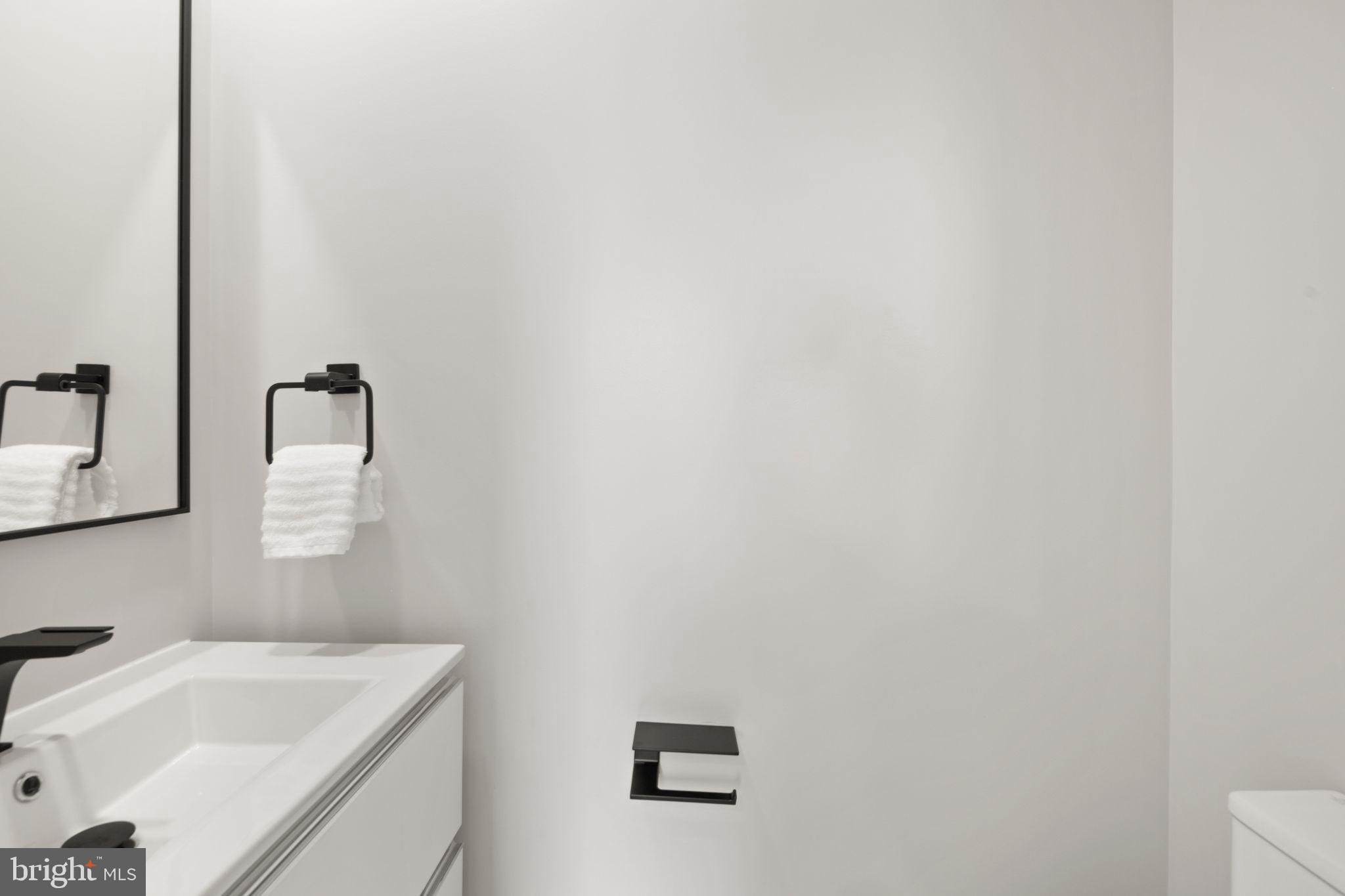 1610 Foxhall Road Northwest Washington, DC 20007 - Photo 36 of 66 a bathroom with a sink and mirror