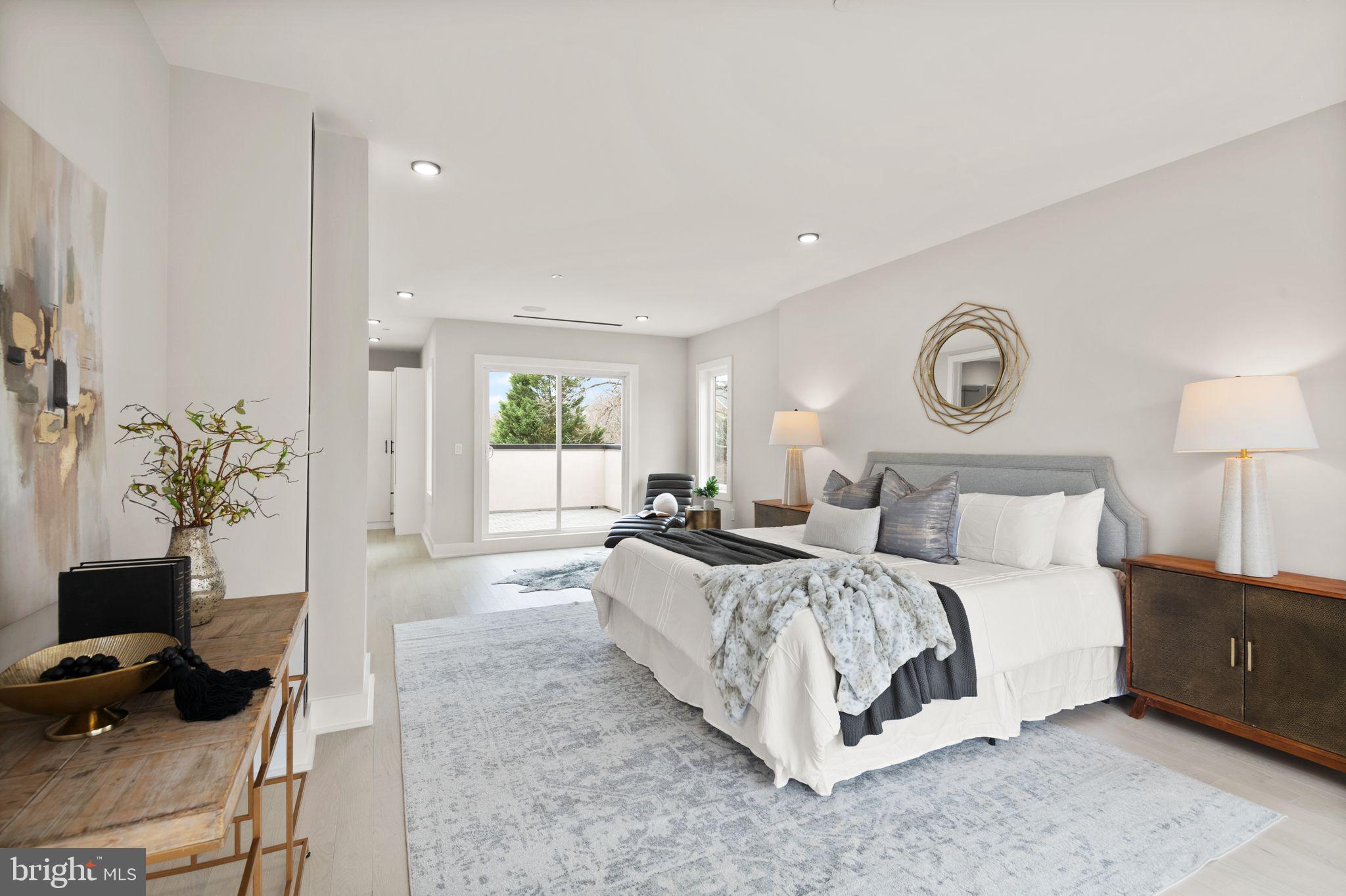 1610 Foxhall Road Northwest Washington, DC 20007 - Photo 38 of 66 a spacious bedroom with a bed a mirror and a window