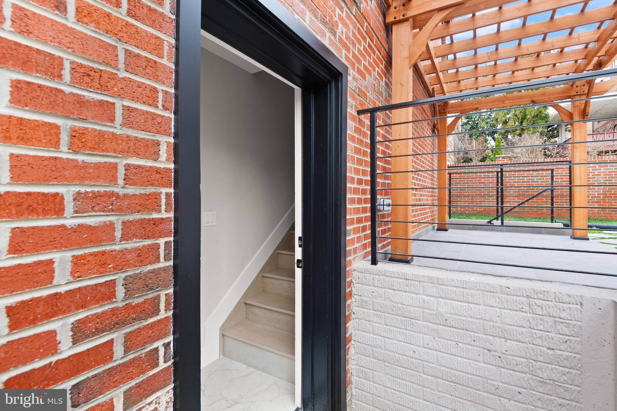 1610 Foxhall Road Northwest Washington, DC 20007 - Photo 52 of 66 a view of a balcony with wooden floor and iron stairs