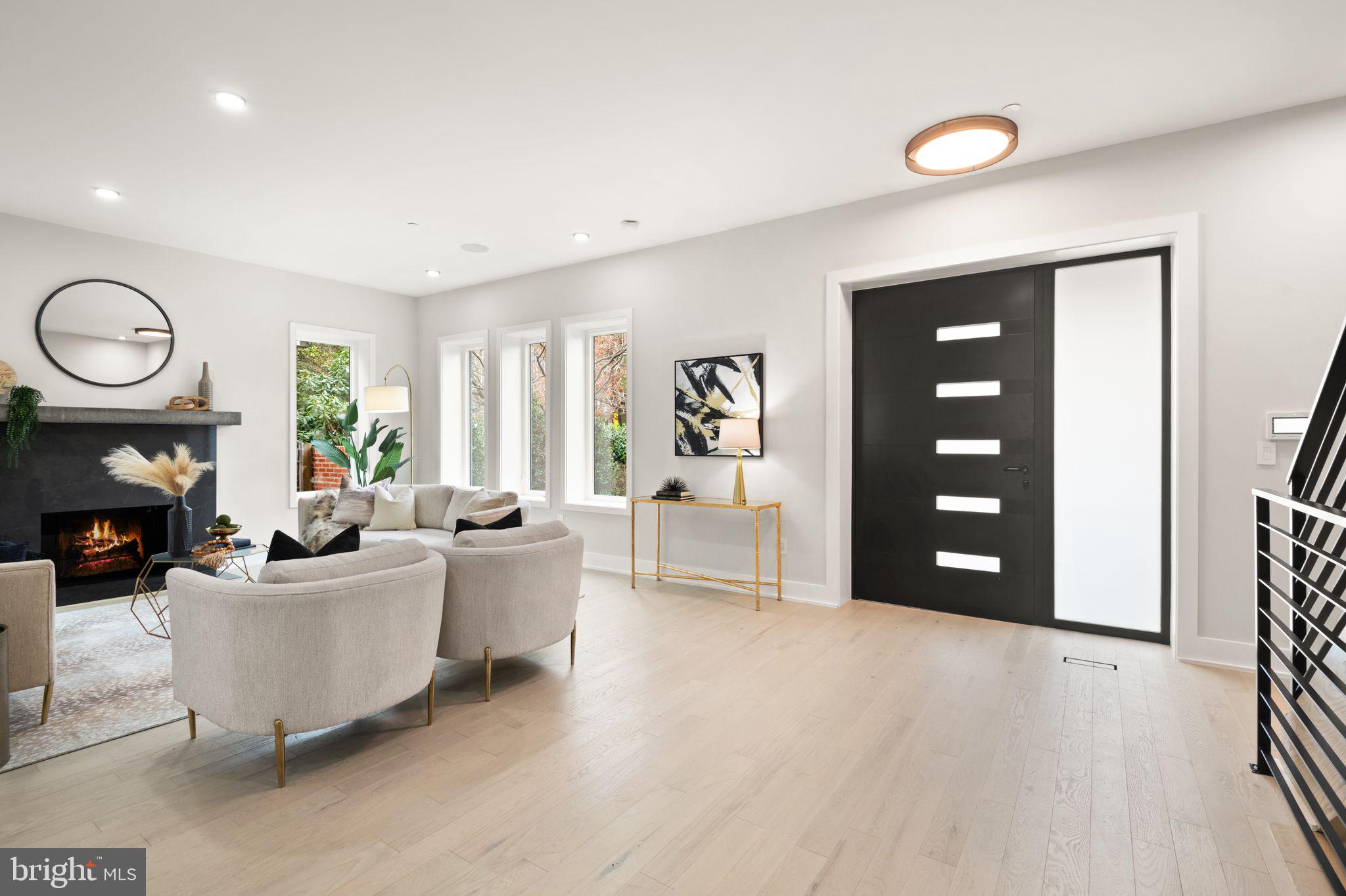 1610 Foxhall Road Northwest Washington, DC 20007 - Photo 8 of 66 a living room with furniture a fireplace and a large window